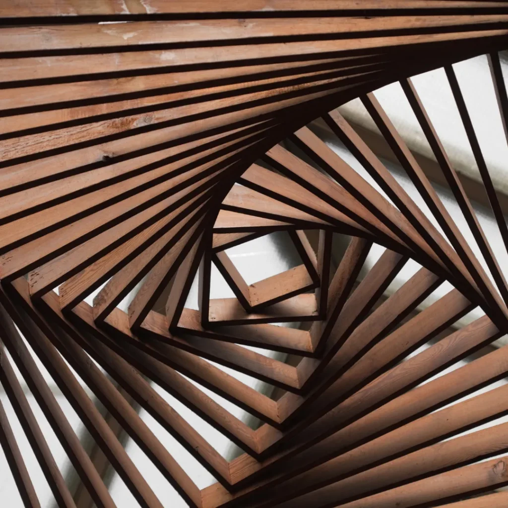 Γεωμετρική σπιράλ κατασκευή από ξύλινες δοκούς για διακόσμηση εσωτερικού χώρου.